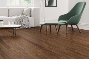 Green chairs and dining table on light brown laminate floor
